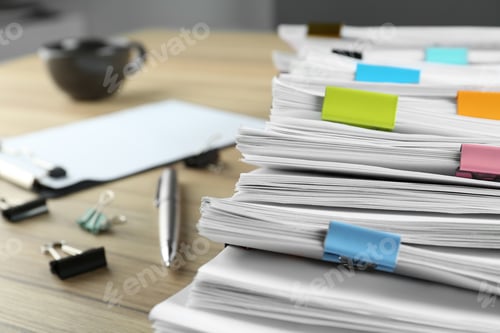 Preview: Stack of documents with binder clips and pen on wooden table, closeup view
