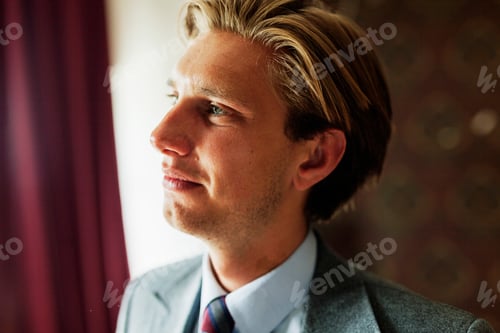 Preview: Close-up of young man looking away at office