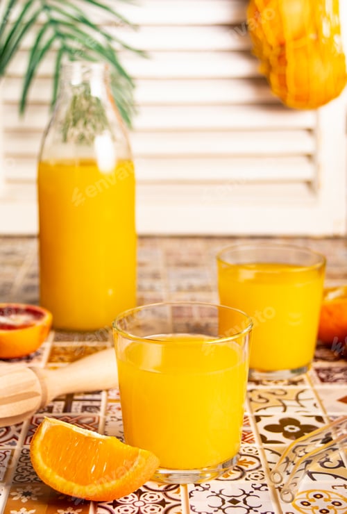 Preview: Fresh orange juice on table with slices fruits.