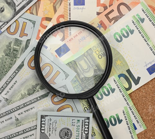 Preview: Magnifier and paper euro and dollar bills. Analysis of exchange rate fluctuations
