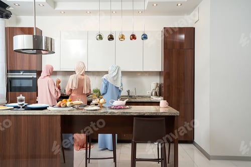 Preview: Three Muslim women cooking dinner in kitchen