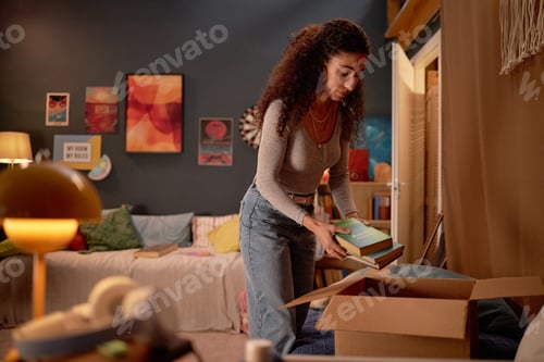Preview: Young Woman Organizing Books in Cozy Room