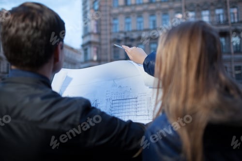 Preview: Man and woman holding blueprint