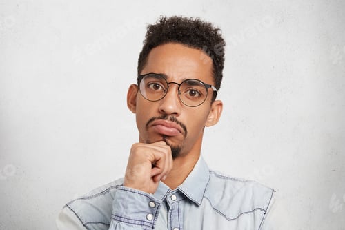 Preview: Hmm not bad. Close up studio portrait of concentrated seruious male manager or boss evaluates work o