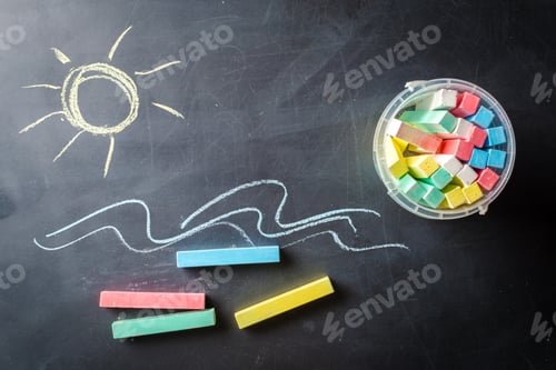 Preview: Dirty and used blackboard and pieces of colored chalk