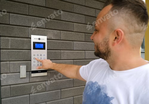 Preview: Man dials the code for the video intercom outside building to go home