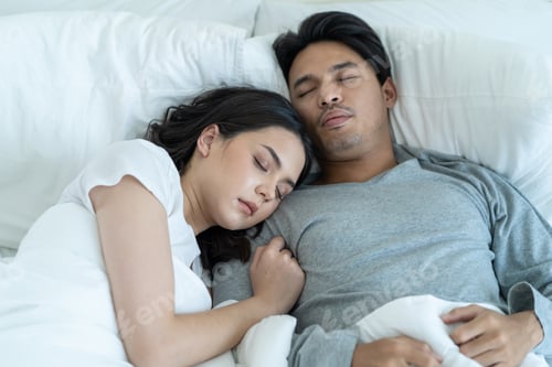 Preview: Asian attractive young couple lying down on bed to sleep in bedroom.
