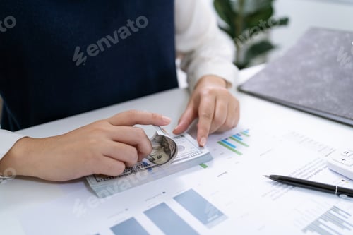 Preview: Businesswoman Accountant analyzing investment charts Invoice and pressing
