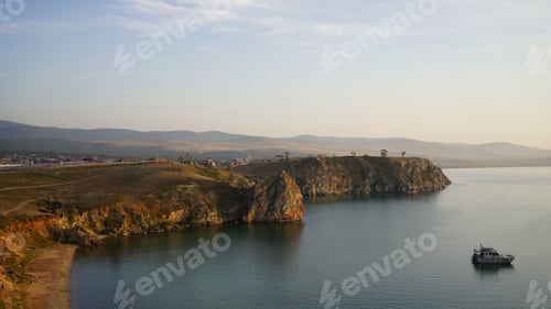 Preview: Landscape of the sea surrounded by cliffs and greenery in the morning