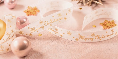 Festive Christmas and New Year background with gold and pink baubles and ribbons