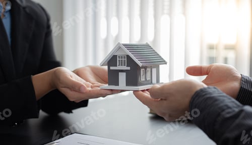 Preview: Business People Handing Over Miniature House Model