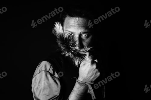 Preview: Grayscale portrait of a South Asian male with a fur hood on a dark background