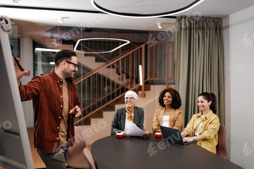 Preview: A casual businessman explains his points to his female colleagues.