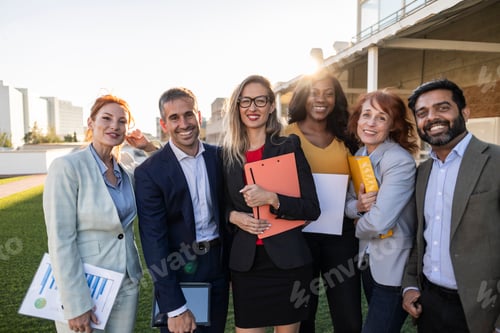 Preview: Multiracial business team smiling outdoors in the city