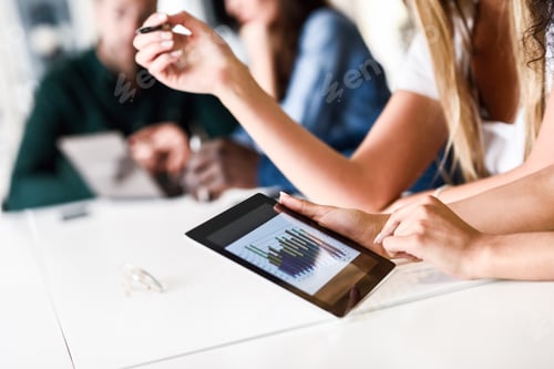 Preview: Group of young men and woman coworking with tablet computer