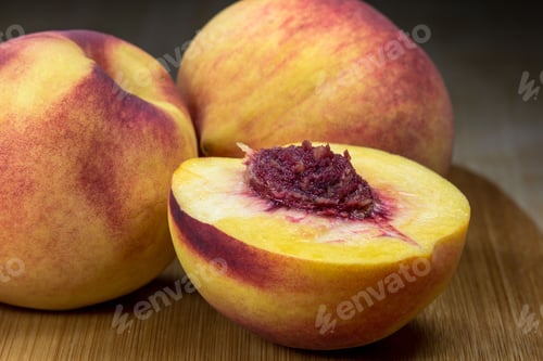 Preview: Close-up shot of three juicy peaches arranged on a bamboo cutting board