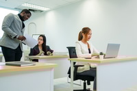 Preview: Successful businesspeople working at office desk.