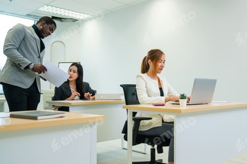 Preview: Successful businesspeople working at office desk.