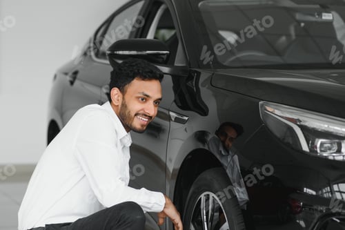 Preview: happy indian man buy new biodiesel eco automobile in lux showroom.
