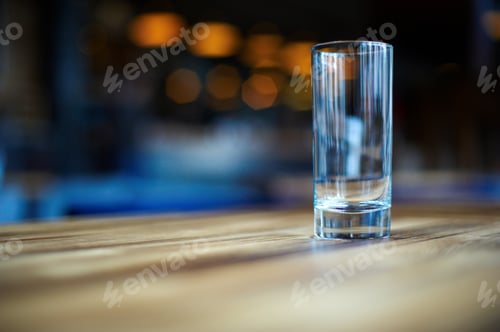 Preview: Empty glass on the dark wooden table in cafe