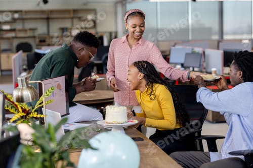 Preview: Celebrating birthday in modern office, African American colleagues sharing cake and laughter