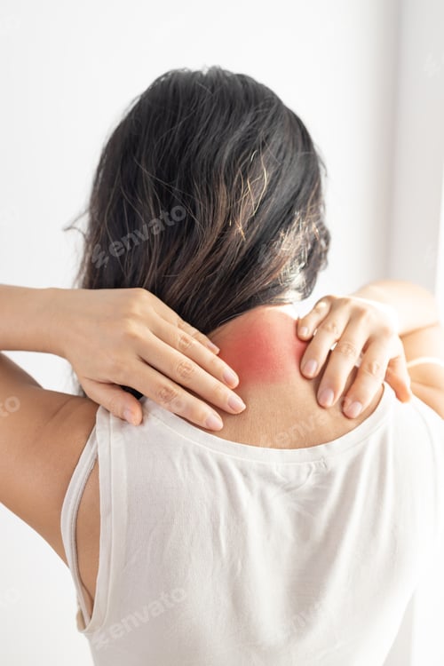 Preview: Young woman feeling tired and suffering from neck pain, health concept.