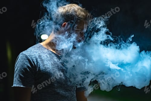 Preview: The man smoking on the street. evening night time