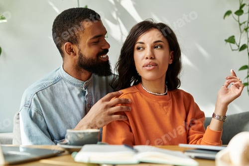 Preview: Creative African American couple collaborating remotely in a cozy cafe setting