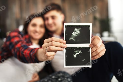 Preview: A young married couple awaiting a baby. Beautiful couple lying in the bedroom make plans for the