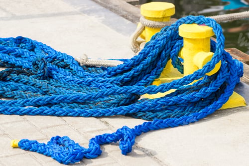 Preview: Blue rope and mooring bollard, detail of seaport, yachting concept