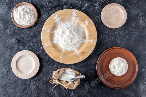 Preview: flat lay with arrangement of wooden plates and flour on dark marble tabletop