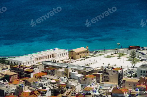 Preview: view from the height of the Church of the island of Zakynthos.In the distance, a ferry sails across