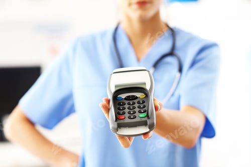 Preview: Female doctor standing in her office with payment terminal