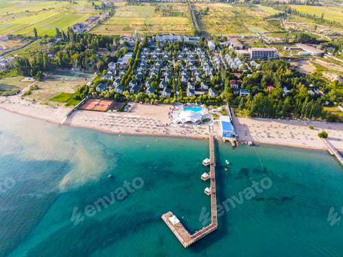 Preview: Aerial view of a resort with a long pier and swimming pool