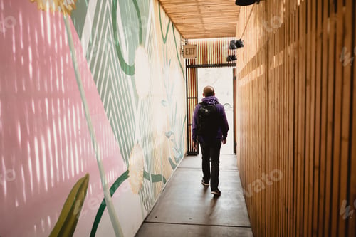 Preview: Man walking through pastel bright artistic hipster wood shadow light hallway colorful abstract shape