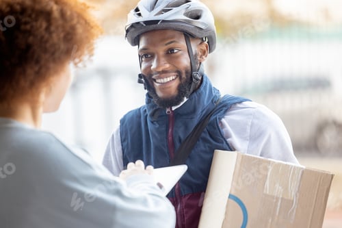 Preview: Black man, box and smile for delivery service, package or female customer order in city. Happy Afri
