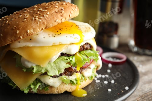 Preview: Tasty burger with fried egg on tray against blurred background, space for text