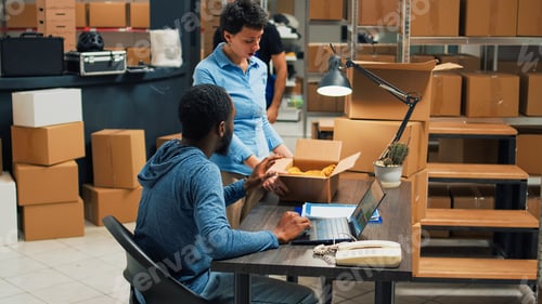 Preview: Team of startup partners doing quality control on products from storage room