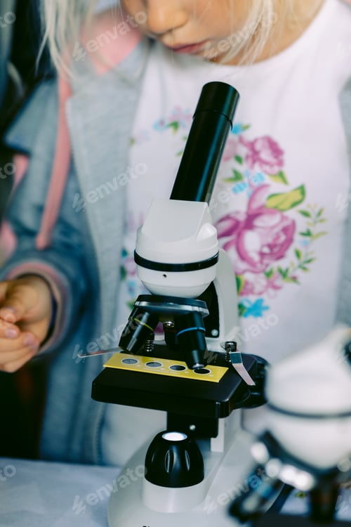 Preview: Modern white microscope on blurred background. Concept of teaching biochemistry to students and