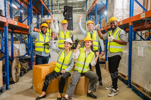 Preview: Group of happy warehouse workers celebrating success in warehouse