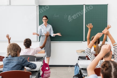 Preview: back view of multiethnic pupils with hands in air, and teacher standing with open arms near