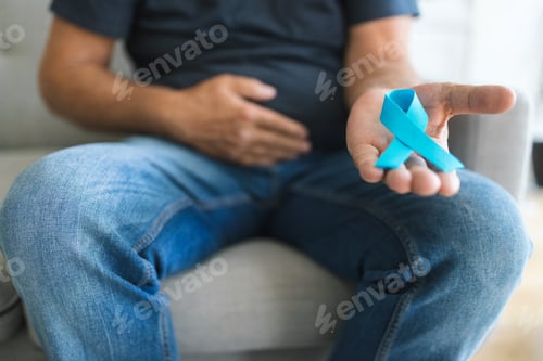 Preview: Senior man holding a blue cancer awareness ribbon