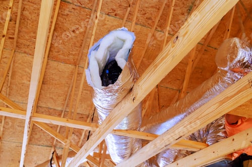 Preview: In construction of home, silver insulation ventilation HVAC pipes were installed from ceiling to a