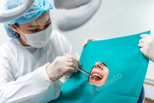 Preview: Caucasian dentist examine tooth for young girl at dental health clinic.