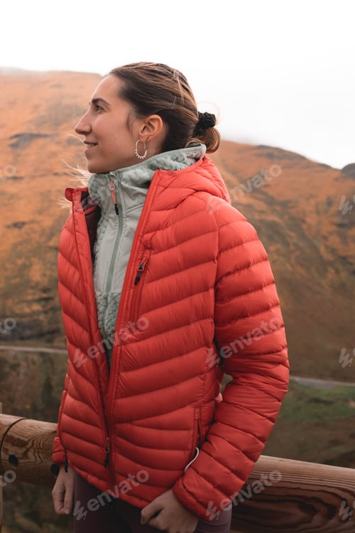 Preview: Side Profile of Woman in Red Jacket Admiring Mountain Landscape