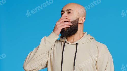 Preview: Middle eastern man feeling exhausted and yawning in studio