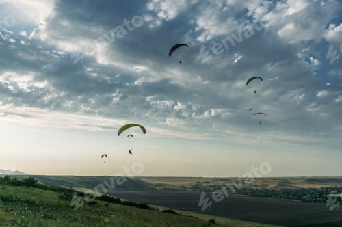 Preview: Parachutists gliding in blue sky over scenic landscape of Crimea, Ukraine, May 2013