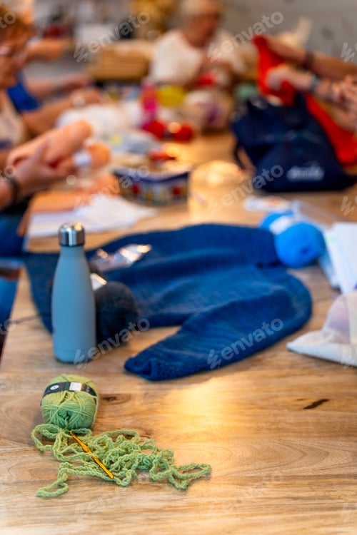 Preview: Crochet club. Elderly women knitting together in a workshop.