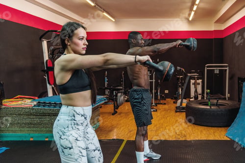 Preview: Two people are working out in a gym