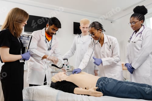 Preview: Medical Students Practicing CPR on a Dummy During a Training Session